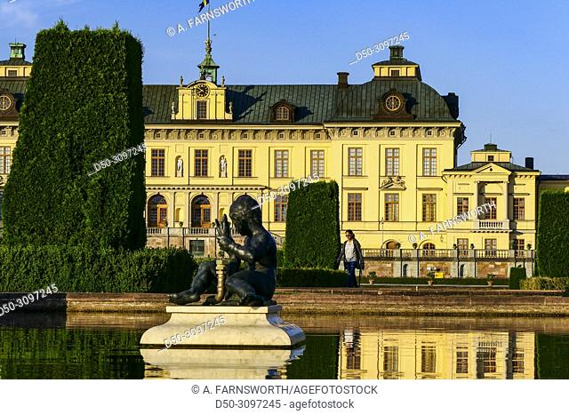 Stockholm, Sweden A pond and reflection of a visitor at The Royal Palace, Drottningholm