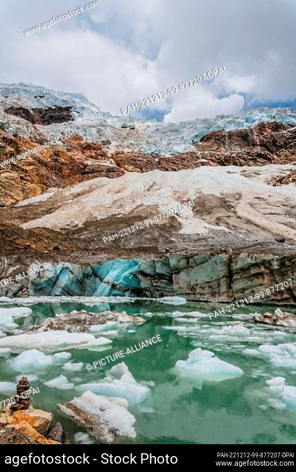 08 December 2022, Peru, Ancash: Pieces of ice float in a lagoon that was recently formed in the Paccharuri Gorge. Known by residents of the area as the ""Frozen...