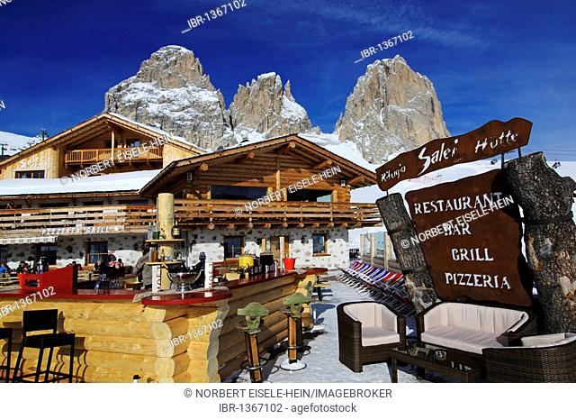 Skiers in front of the Rifugio Salei bar and restaurant, Sella Pass, Sassolungo Mountain, Sella Ronda ski trail, Val Gardena, Alto Adige, Italy, Europe