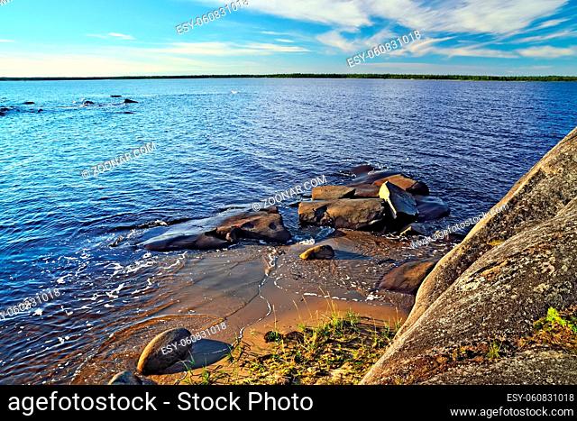 Beautiful red cliffs on the shore of the White sea. North Karelia, Russia