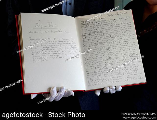 02 February 2023, Schleswig-Holstein, Lübeck: Jörg-Philipp Thomsa, director of the Grass House, holds up a handwritten manuscript of ""Grimm's Words"" by Nobel...