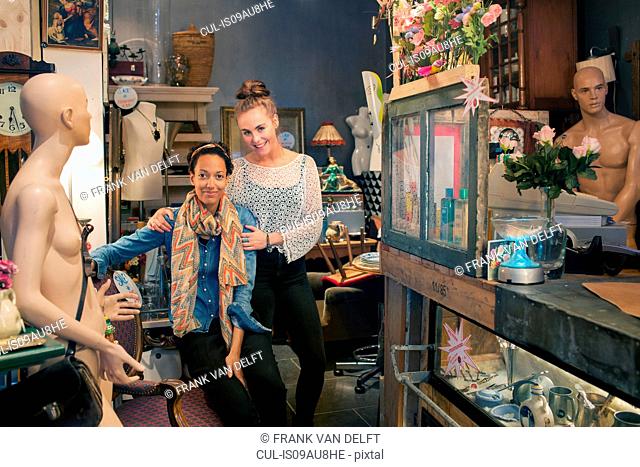Portrait of two female colleagues in vintage shop