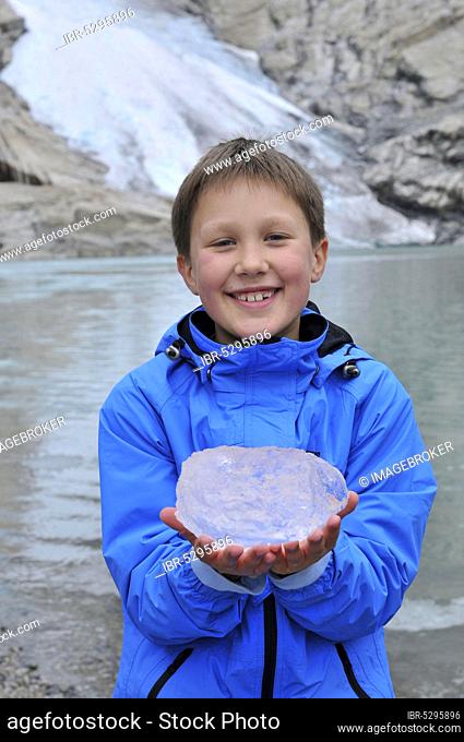 Boy with ice, Briksdalsbreen glacier, glacier tongue, Briksdalen, Stryn, Sogn og Fjordane, Norway, glacier ice, Europe