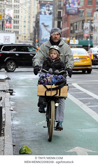 Liev Schreiber takes his two sons, Samuel and Alexander, to school on his bicycle with Naomi Watts tailing on her citi-bike on a cold winter morning in...