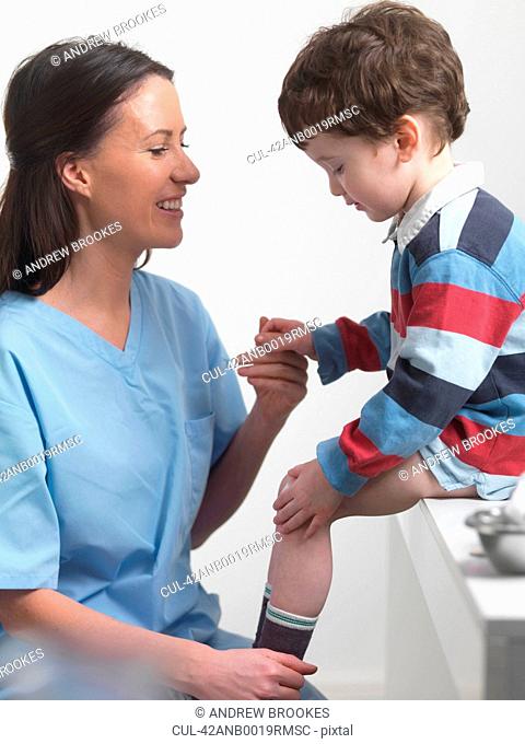 Nurse talking to boy in doctors office