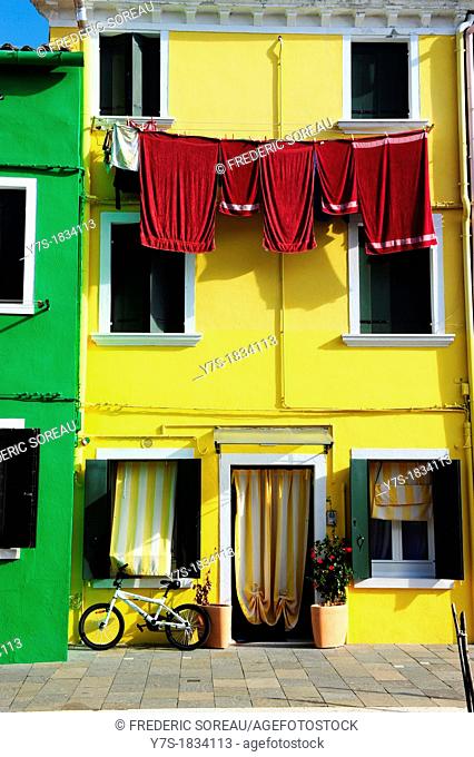 Colorful houses with hanging laundry in the island of Burano near Venice, Italy, Europe