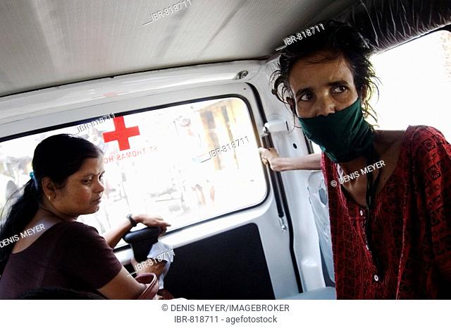 Najira Begum, 35, diagnosed with multi-resistant tuberculosis, in an ambulance with a female social worker on the way to an x-ray examination, Howrah, Hooghly