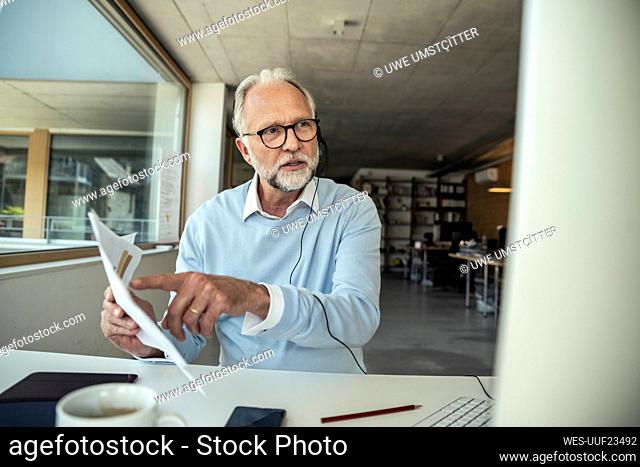 Businessman explaining strategy while discussing during video call on computer at office