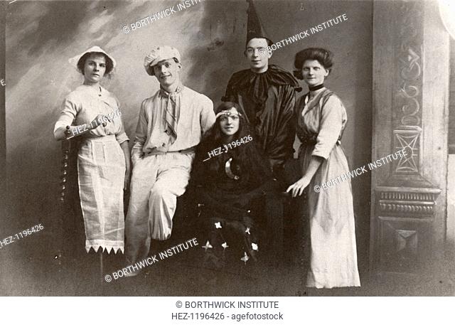 Five costumed figures possibly actors, pose for a studio shot, 1913