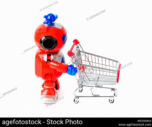 Toy robot and shopping cart isolated on white background