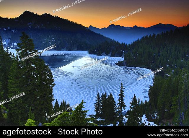 Sunset Over a Partailly Frozen Snow Lake in the Alpine Lakes Wilderness of Washington