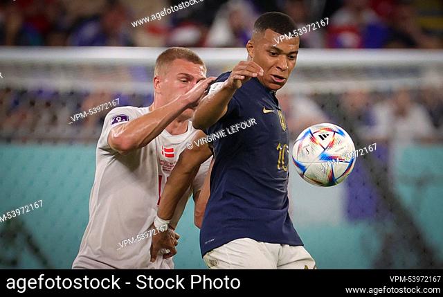 Danish Rasmus Kristensen and France's Kylian Mbappe fight for the ball during a soccer game between France and Denmark, in Group D of the FIFA 2022 World Cup
