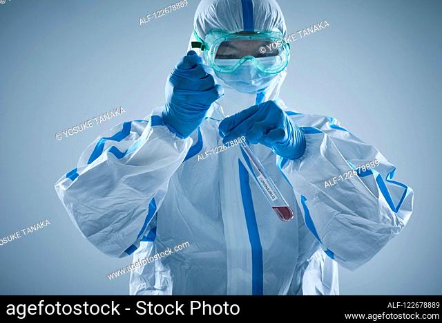 Japanese man wearing protective suit for disease prevention