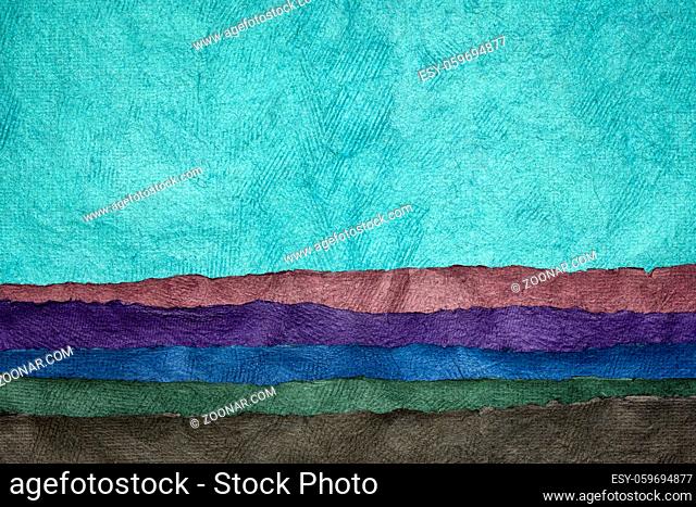 abstract landscape in blue tones created with sheets of textured colorful handmade paper