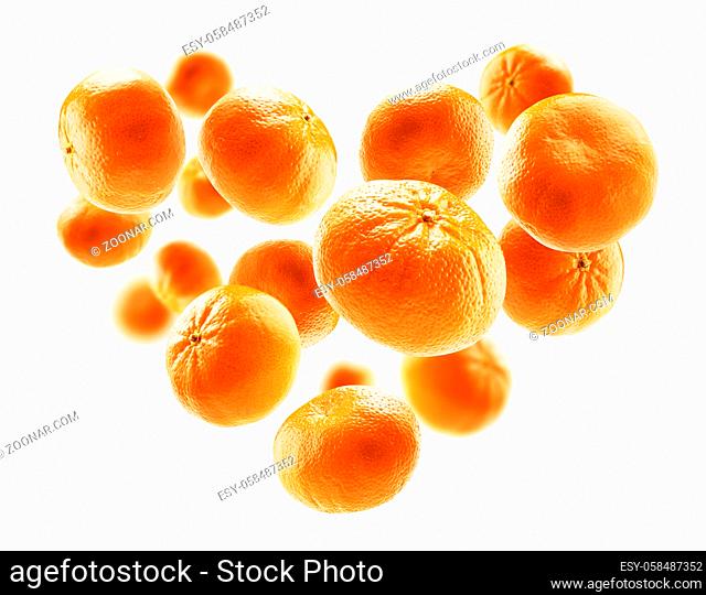 Ripe tangerines in the shape of a heart on a white background