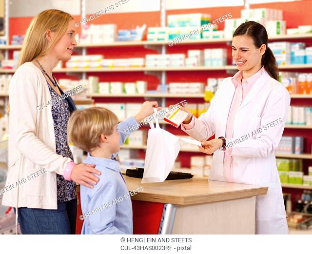 Pharmacist filling prescription in store