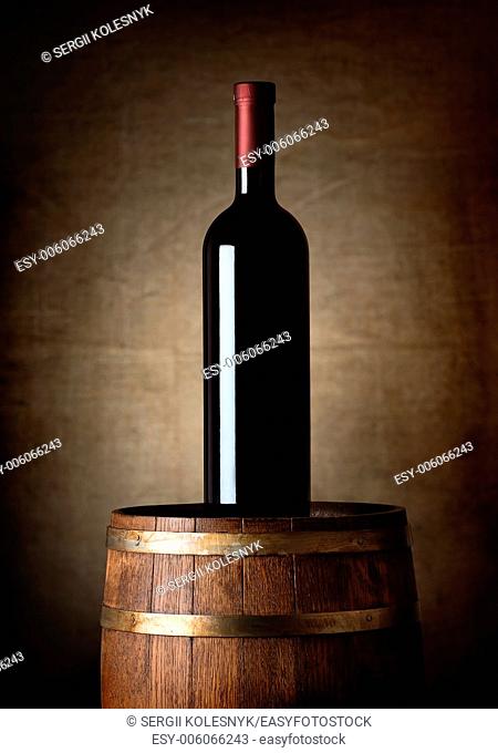 Bottle of wine on an old barrel
