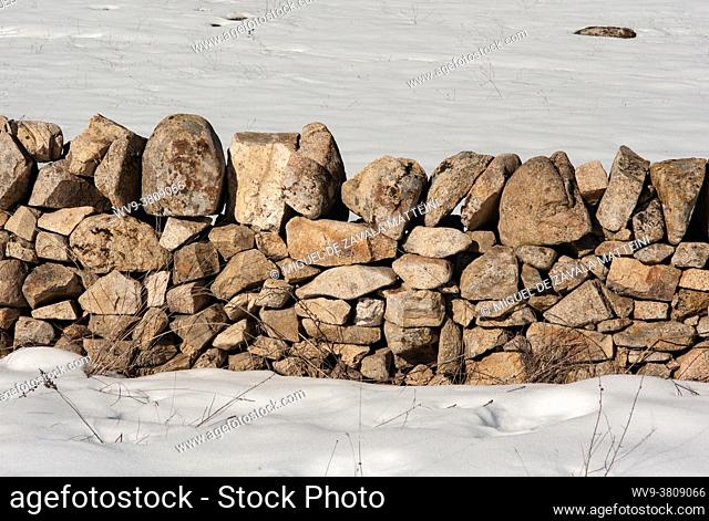 Stone fences in the field with snow