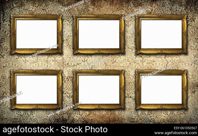 Golden vintage picture frame set with blank space on an old wall. Copy space, add photo or text