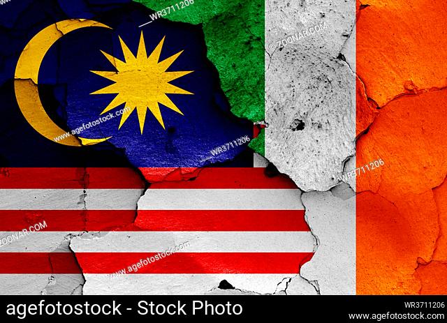 flags of Malaysia and Ireland painted on cracked wall
