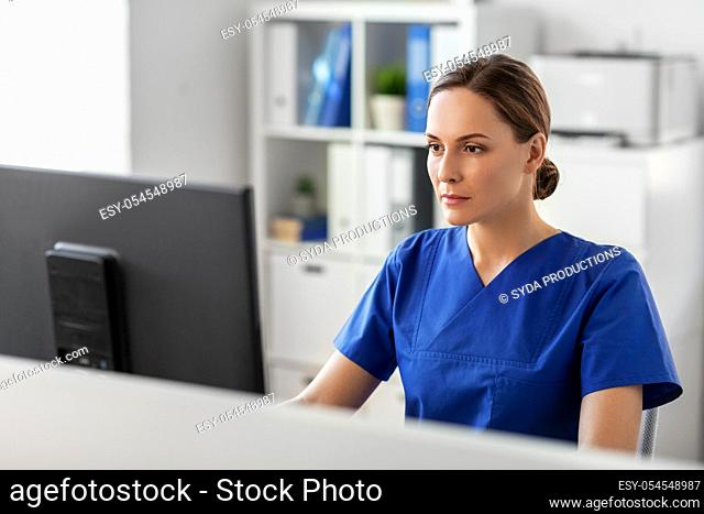 doctor or nurse with computer working at hospital