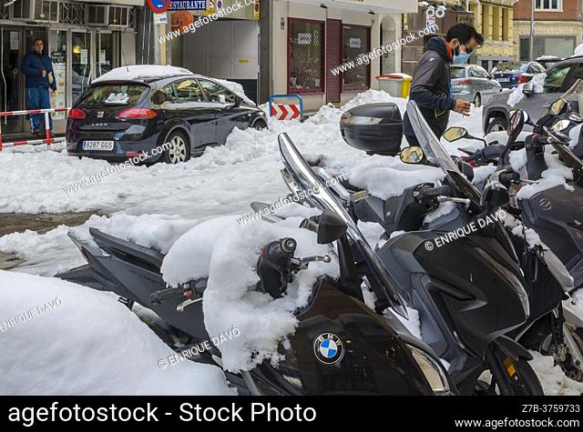 Madrid, Spain. 10 th January 2021. View of motorcycles in San Bernardo street, Chamberi quarter, after Filomena snow storm