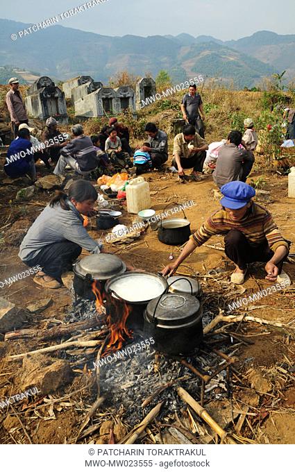 Women are cooking food with water and ingredients they carried on the stick all the way to the mountaintop Yunnan, China April 4, 2009 Part of the photo feature