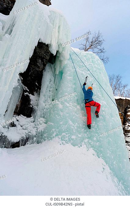 Ice climbing on a frozen waterfall in Abisko National Park, Sweden