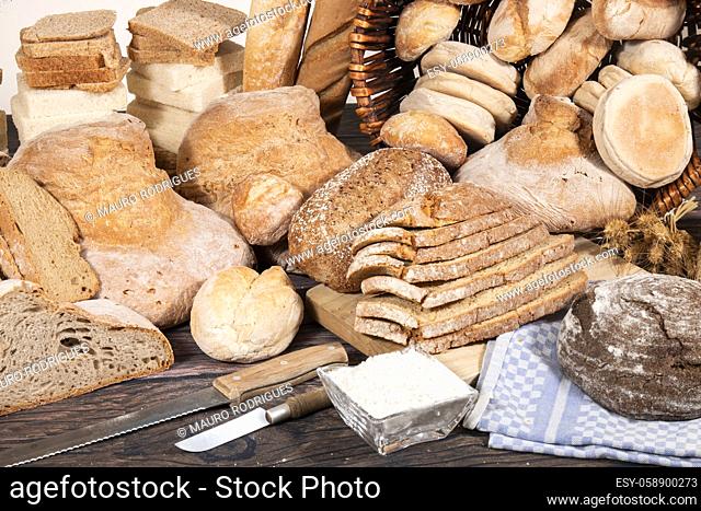 Fresh Assortment of several baked bread varieties on a wooden table