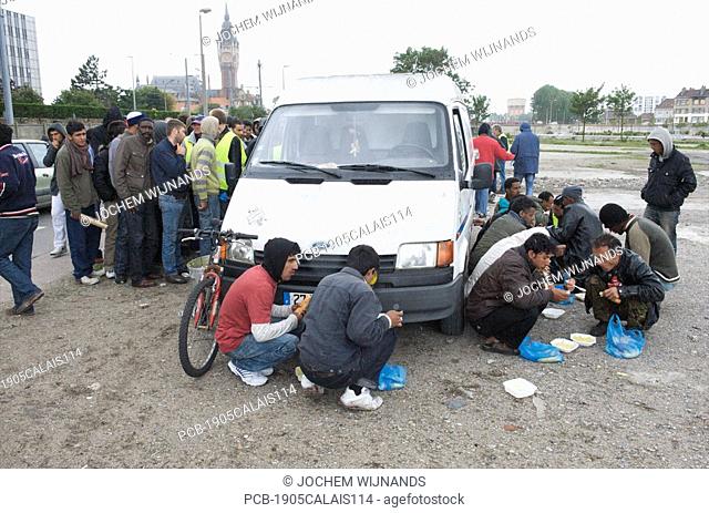 Calais, refugees hoping to reach the UK are receiving food from charity groups