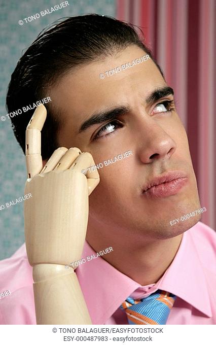 Businessman retro thinking with wooden finger over wallpaper vintage background