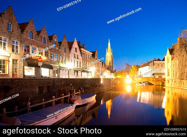 Bruges, Belgium - April 18, 2017: Dijver Canal and the Our Lady Church of Bruges, Belgium