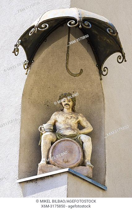 Bacchus statue in a building facade. Maribor. Lower Styria region. Slovenia, Europe