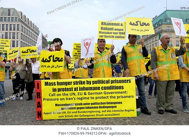 Demonstrators pose with banners and signs in front of Brandenburg Gate in Berlin, Germany, 26 August 2017. The National Resistance Council (NWRI) in Germany has...