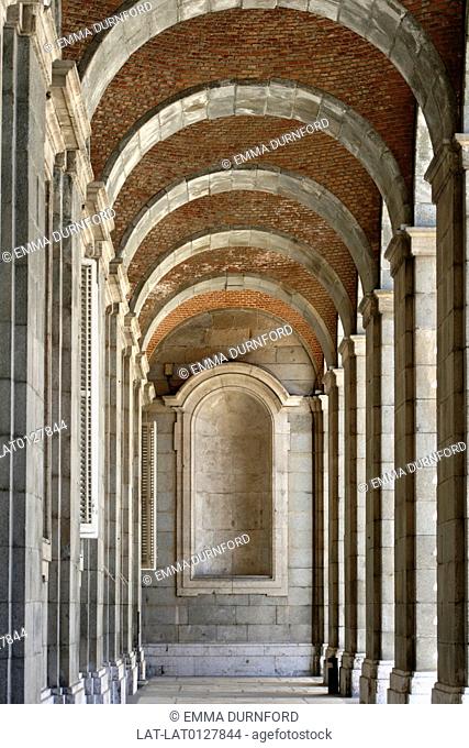 Red brick and stone arches of the passageway leading to the Real Armeria Royal Armoury off of the Plaza de Armas in the Palacio Real Royal Palace