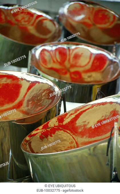 Detail of steel band drums with red reflections