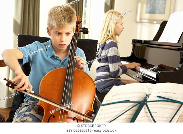Boy and girl playing cello and piano at home