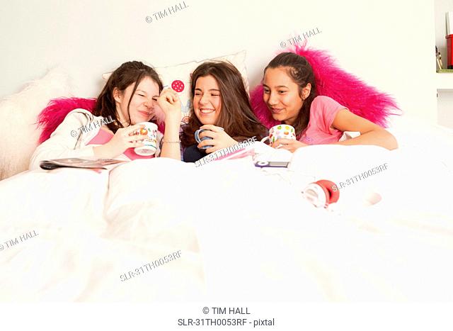 teenage girls laughing and playing music