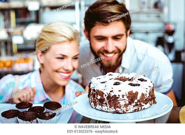 Cute couple on a date looking at a chocolate cake