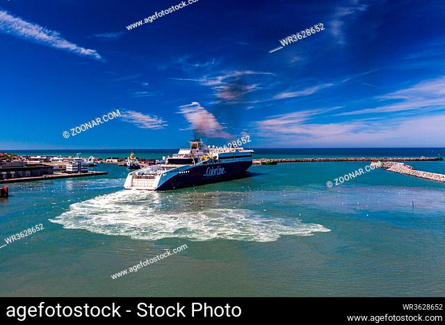 HIRTSHALS, DENMARK - JUNE 18: maneuver of a blue and white Color Line ferry as it leaves the harbor on June 18, 2013 in Hirtshals, Denmark