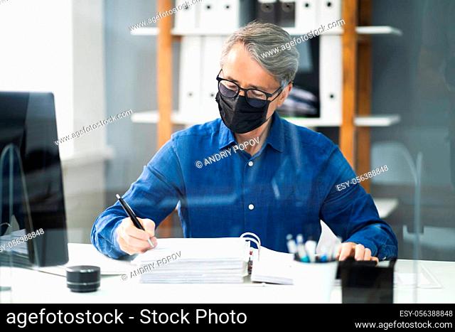 Senior Accountant Man Working With Invoice In Face Mask