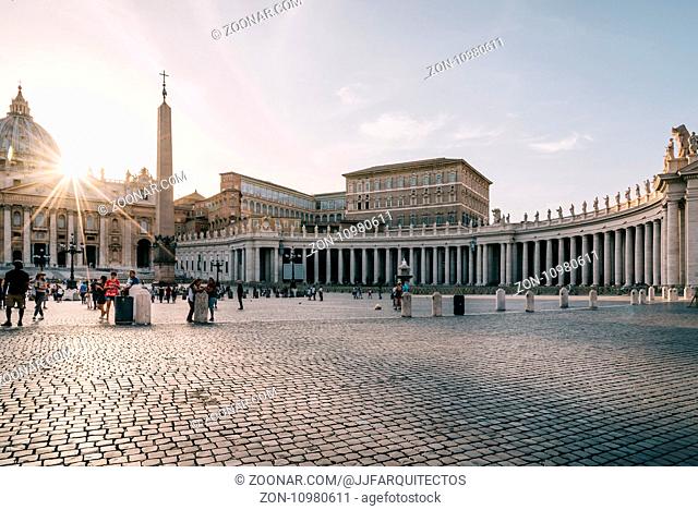 Rome, Italy - August 19, 2016: Square of St Peter at sunset with sunlight at background. It is located directly in front of St