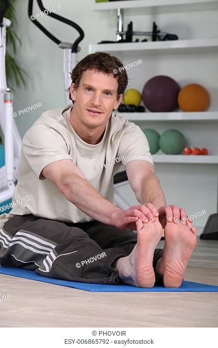 red-haired man doing stretching exercises