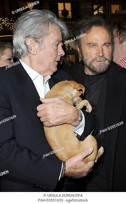 Actors Alain Delon (R) and Franco Nero pose with Molly the dog at a traditional Christmas display at the Gut Aiderbichl animal sanctuary in Salzburg,  Austria