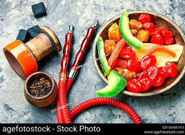 Details of oriental hookah and shisha tobacco with candied fruit flavors.Shisha and exotic dried fruits