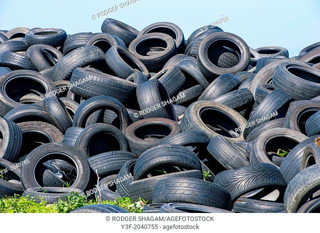 Old tyres dumped in an empty field. The end of the road. Tire graveyard. Cape Town, South Africa