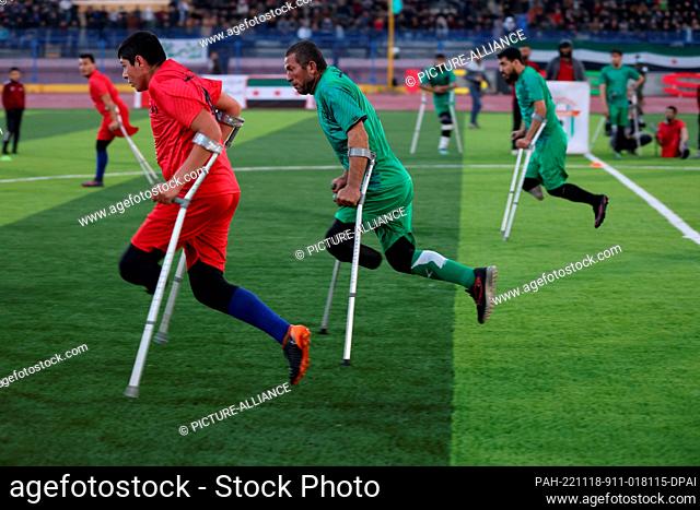 18 November 2022, Syria, Idlib: Foot amputees take part in a football match during the opening of the Idlib city stadium by Syrian Salvation Government