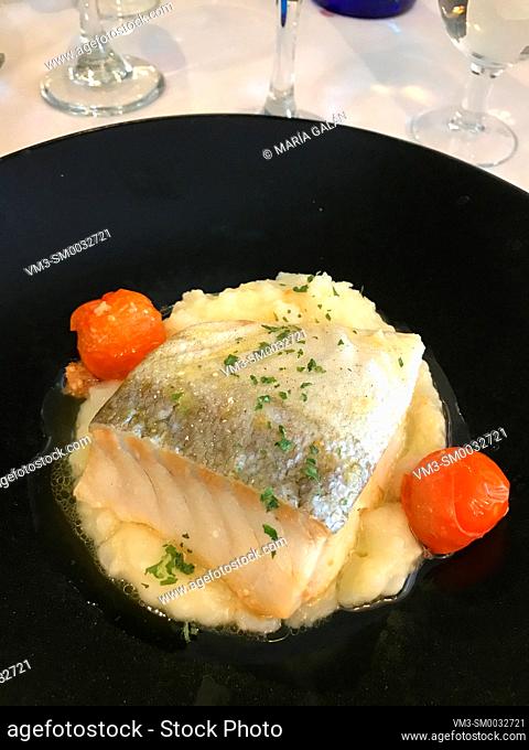 Cod loin with alioli sauce and cherry tomatoes. Spain