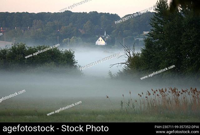 11 July 2023, Mecklenburg-Western Pomerania, Rostock: After a relatively cool night, fog rolls in early in the morning. A sunny day awaits the north