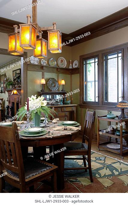 DINING ROOM: Mission style, Arts and Crafts mica shaded oak chandelier, serving cart with pottery and wicker lamp, plate rail, round dining table